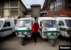 Januka Shrestha, 25, a Tuk Tuk driver, poses for a picture in Kathmandu, Nepal, Feb. 26, 2017.