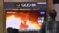 FILE - People watch a television screen showing a news broadcast with file footage of a North Korean missile test, at a railway station in Seoul on Jan. 25, 2022.