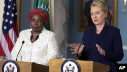 Secretary of State Hillary Rodham Clinton speaks to the media as African Union Chairperson Nkosazana Dlamini-Zuma, left, listens after their meeting at the Department of State in Washington, Wednesday, Nov. 28, 2012. 