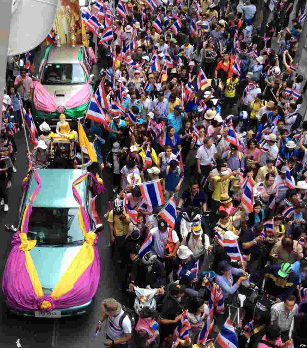 Some of the thousands of anti-government demonstrators walking along Phloen Chit Road as seen from the skywalk at the Chit Lom BTS station in central Bangkok, Dec. 9, 2013. (Steve Herman/VOA)