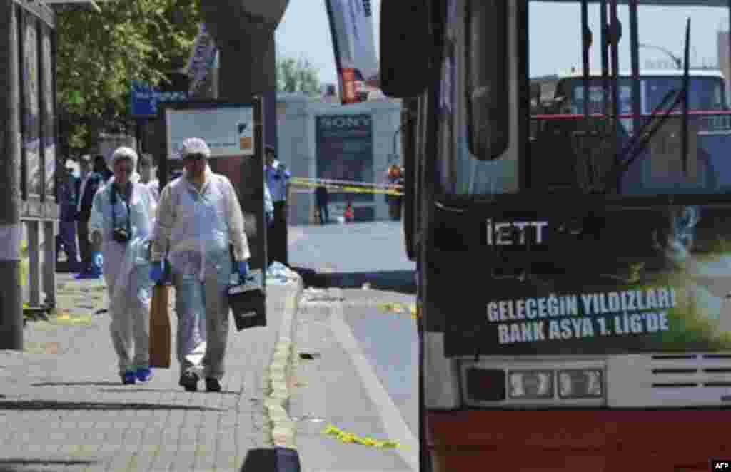 Forensic experts work at the scene after a bomb exploded at a bus stop during rush hour in Istanbul, Turkey, Thursday, May 26, 2011. Seven people were injured as several ambulances rushed to the scene on a multi-lane thoroughfare in a busy commercial sect