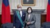 资料照片：台湾总统府提供的照片显示台湾总统蔡英文在台北颁授法国参议院友台小组主席李察“特种大绶卿云勋章” 。（2021年10月7日)