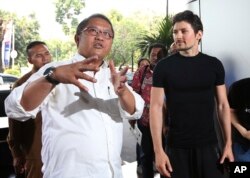 Indonesian Communication and Information Minister Rudiantara, left, accompanied by Telegram co-founder Pavel Durov, right, speaks as they meet in Jakarta, Aug. 1, 2017.