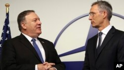 U.S. Secretary of State Mike Pompeo, left, speaks with NATO Secretary General Jens Stoltenberg prior to a meeting at NATO heaquarters in Brussels, Dec. 4, 2018.