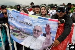 People wait for the arrival of Pope Francis to celebrate mass at the Enrique Olaya Herrera airport of Medellin, Colombia, Sept. 9, 2017.