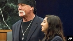 Former professional wrestler Hulk Hogan, left, stands with attorney Seema Ghatnekar, in a courtroom in St. Petersburg, Fla., March 18, 2016. A jury awarded Hogan $115 million in an invasion of privacy case against Gawker Media.