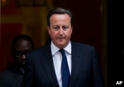 FILE - David Cameron, then the prime minister of Britain, leaves 10 Downing St. in London, to be driven to the Houses of Parliament for a debate and vote on Syria, Aug. 29, 2013.