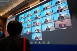 FILE - Monitors show leaders attending the first virtual Asia-Pacific Economic Cooperation (APEC) leaders' summit, hosted by Malaysia, in Kuala Lumpur, Malaysia, Nov. 20, 2020.