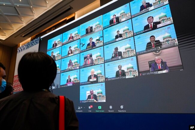 FILE - Monitors show leaders attending the first virtual Asia-Pacific Economic Cooperation (APEC) leaders' summit, hosted by Malaysia, in Kuala Lumpur, Malaysia, Nov. 20, 2020.