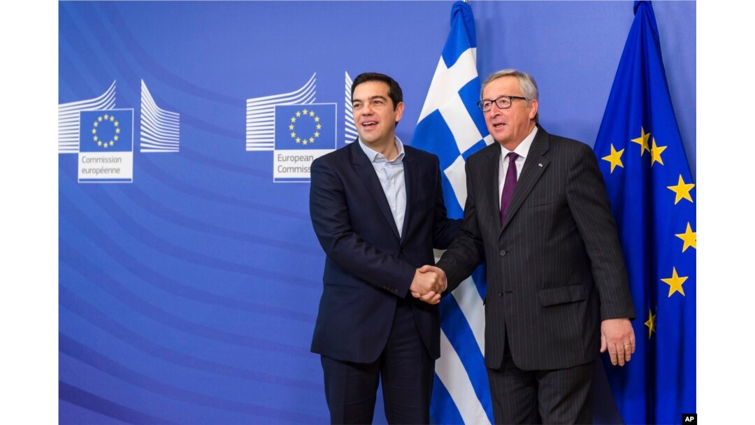 FILE - European Commission President Jean-Claude Juncker, right, welcomes Greece's PM Alexis Tsipras upon his arrival at the European Commission headquarters in Brussels, Feb. 4, 2015.