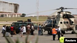 A Kenya Air Force helicopter transports the bodies of Ugandan Army personnel who died in a helicopter crash on Mount Kenya on Sunday is parked on the tarmac at Wilson Airport in Nairobi, Kenya, August 15, 2012