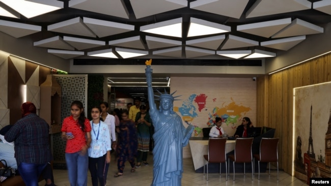 Students walk in the lobby of Western Overseas, an institute providing coaching for English language proficiency tests and visa consultancy, in Ambala, India, August 4, 2022. REUTERS/Anushree Fadnavis