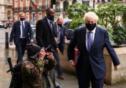 British Prime Minister Boris Johnson is seen outside the BBC headquarters, as the spread of the coronavirus disease (COVID-19) continues, in London, October 4, 2020.