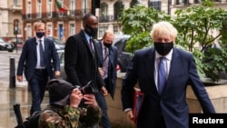 British Prime Minister Boris Johnson is seen outside the BBC headquarters, as the spread of the coronavirus disease (COVID-19) continues, in London, Britain, Oct. 4, 2020. 