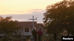 FILE - Recently installed solar lights mark burial sites on Cowessess First Nation, where a search had found 751 unmarked graves from the former Marieval Indian Residential School near Grayson, Saskatchewan, Canada, July 6, 2021. 