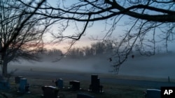 FILE - Morning fog blankets a cemetery in West Virginia, March 17, 2021. The number of US suicides fell nearly 6% in 2020 amid the coronavirus pandemic — the largest annual decline in at least 40 years, preliminary government data show.