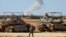 Israel's army tanks take position near the border with the Gaza Strip as smoke billows over the Palestinian enclave during Israeli bombardment on May 6, 2024,