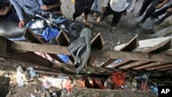 A slipper of an injured commuter is seen stuck on the railing of a pedestrian bridge where a stampede took place at the Elphinstone station, in Mumbai, India, Sept. 29, 2017.