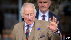 FILE - Britain's King Charles III waves during his visit to the Discovery Center and Auld School Close in Tomintoul, Scotland, Sept. 13, 2023.