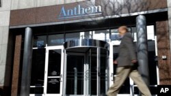 A man walks past health insurer Anthem's corporate headquarters in Indianapolis, Thursday, Feb. 5, 2015.