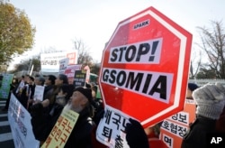 South Korean protesters stage a rally to oppose the General Security of Military Information Agreement between South Korea and Japan, in front of the Defense Ministry in Seoul, Nov. 23, 2016. The intelligence-sharing agreement is designed to better deal with threats from North Korea, officials said. The signs read "Stop, the military agreement between South Korea and Japan."
