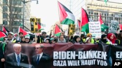 FILE - Anti-war activists march to the White House during a pro-Palestinian demonstration asking to cease fire in Gaza, at Freedom Plaza in Washington, January 13, 2024