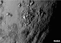 NASA reveals new close-up images of a region near Pluto’s equator reveal a giant surprise: a range of youthful mountains, July 15, 2015.