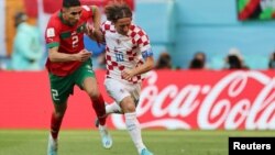 Moroccan right back Achraf Hakimi competes with Croatian midfielder Luka Modric for the ball during the first Group F match between Morocco and Croatia at the 2022 FIFA World Cup, Qatar, November 23, 2o22.