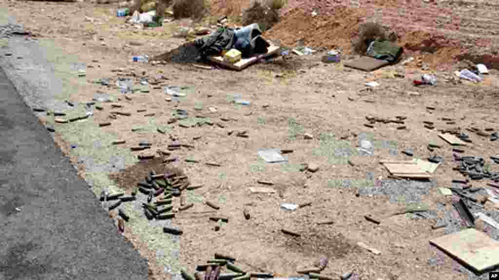 Shell casings litter the ground at a checkpoint north of Bani Walid, Libya, September 10, 2011. - E. Arrott