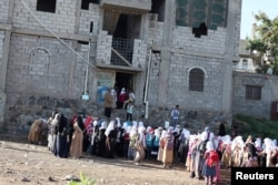 Students gather for a morning drills outside of the teacher's house, who turned it into a makeshift free school, in Taiz, Yemen, Oct. 18, 2018.