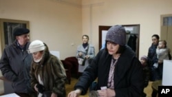 Croatian voters cast their ballots at the polling station in Zagreb, Croatia, January 22, 2012.