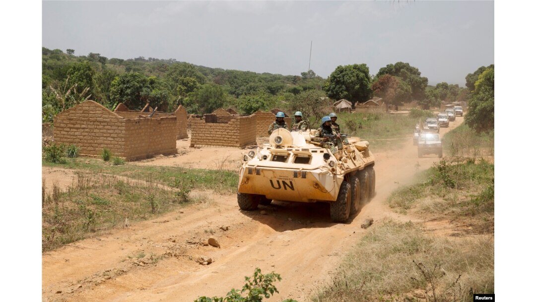 United Nations peacekeeping force vehicles drive by houses destroyed by violence in September, in the abandoned village of Yade, Central African Republic, April 27, 2017.