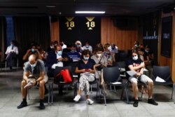 FILE - People sit after they received a coronavirus disease (COVID-19) vaccine as the country extends vaccination to curb surge among population under 30, in Madrid, Spain, July 12, 2021.