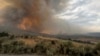 FILE - In this image provided by the U.S. Department of Agriculture Forest Service, smoke rises from a wildfire on July 22, 2024, near Durkee, Ore. 