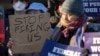 FILE - Demonstrators rally in support of federal workers outside of the U.S. Department of Health and Human Services on Feb. 14, 2025, in Washington. A federal judge on March 13, 2025, ordered six U.S. agencies to reinstate some fired workers.