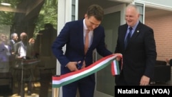 Hungarian State Secretary for Economic Strategy László György, left, cuts a ribbon as Ambassador László Szabó looks on at the opening ceremony of a business promotion center in Washington in May 2019.