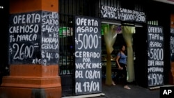 A woman leaves a market in Buenos Aires, Argentina, Thursday, Jan. 4, 2024. Argentina has one of the world's highest inflation rates. 