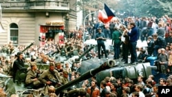 FILE - Czech youngsters holding Czechoslovakian flags stand atop an overturned truck as other Prague residents surround Soviet tanks on Aug. 21, 1968, as an invasion by the Warsaw Pact armies crushed the so-called Prague Spring reform in former Czechoslovakia 30 year ago.