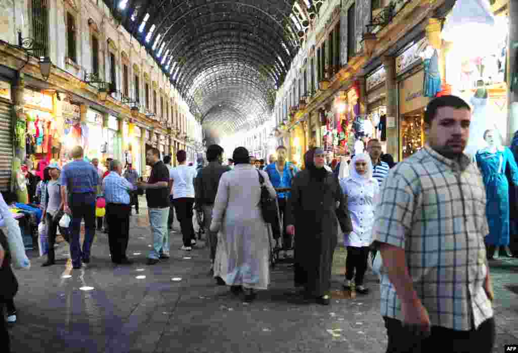 Syrians shop in the covered market in central Damascus as they prepare for the month of Ramadan, July 9, 2013.
