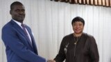 Sudan's Minister of Justice Nasruddin Abdel Bari, left, shakes hands with the International Criminal Court prosecutor Fatou Bensouda during her visit to the capital Khartoum on Oct. 18, 2020.