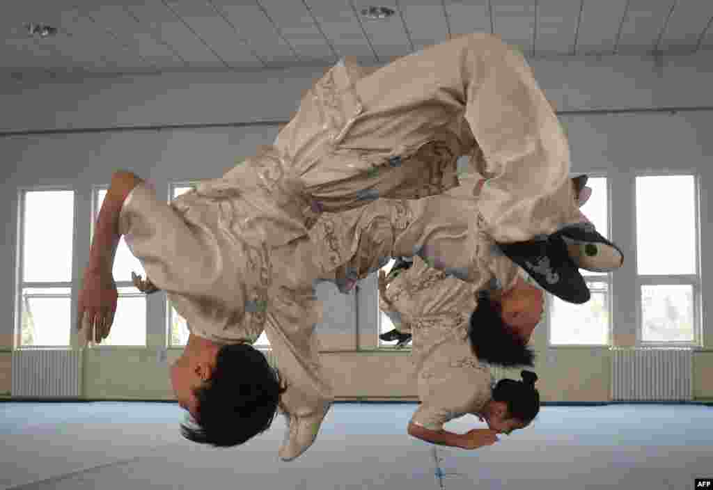 Students from the Huo Yuanjia Martial Arts School perform for visitors during a Wushu training session at their campus in Tianjin, China.