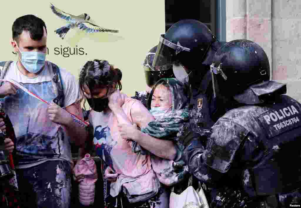 Anti-eviction protesters scuffle with police to prevent eviction of a family from their home at Las Ramblas in Barcelona, Spain.