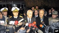 Istanbul Gov. Huseyin Avni Mutlu, center, speaks to the media after a commando raid in the Sea of Marmara, west of Istanbul, Turkey, early Saturday, Nov. 12, 2011.