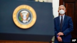 Dr. Anthony Fauci, President Joe Biden's top medical adviser, listens as Biden speaks about the COVID-19 variant named omicron, in the Roosevelt Room of the White House, Nov. 29, 2021.