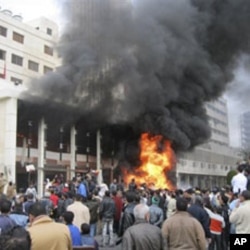The local government headquarters is set on fire by protesters, claiming delays on requests for housing in Port Said, Egypt, February 10, 2011