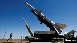 FILE - A serviceman walks past anti-aircraft defense mobile missile systems at the Ashuluk shooting range outside Astrakhan, Russia Aug. 5, 2017. 