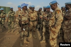FILE - French and Chadian peacekeepers talk at the Minusma peacekeeping base in Kidal, Mali.