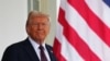 TOPSHOT - US President Donald Trump waits to greet British Prime Minister Keir Starmer at the entrance of the West Wing of the White House in Washington, DC, on February 27, 2025.