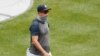 New York Yankees manager Aaron Boone wears a neck gaiter as a mask during a baseball summer training camp workout at Yankee Stadium, July 8, 2020, in New York.