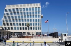 FILE - A U.S. flag flies at the U.S. embassy in Havana, Cuba, Aug. 14, 2015. U.S. investigators are chasing many theories about what harmed American diplomats in Cuba.